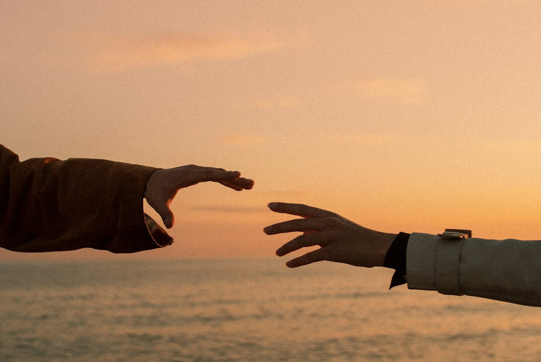 Business partners shaking hands across a table